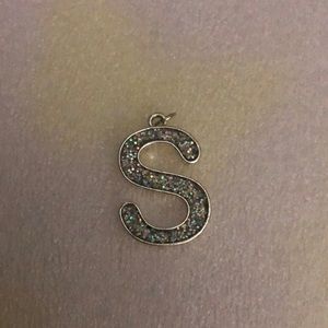 An S pendant for a necklace.